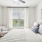 bedroom with art on the wall and lamps on the side of the bed