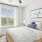 bedroom with a large window and dresser