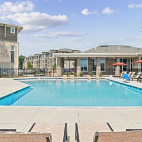 Relax and unwind poolside pool with lounge chairs
