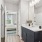 bathroom with dark cabinets and a white counter top
