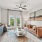 living room with a tv, couch, coffee table, and fan